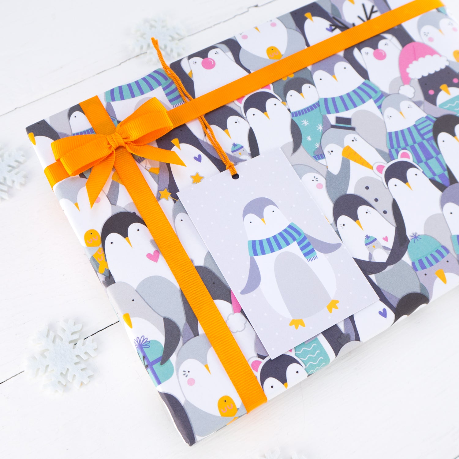 A close up of the penguin gift wrap and matching gift tag.