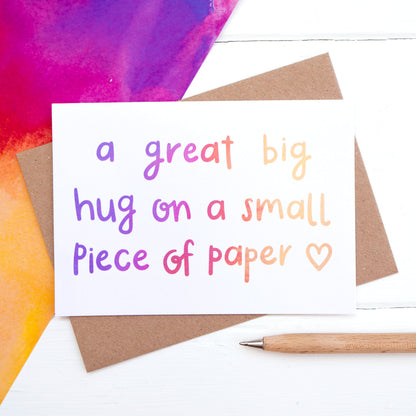 A great big hug on a small piece of paper, sympathy card flatlay.